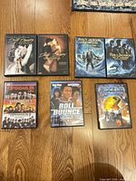 All seven DVD cases arranged on hardwood floor