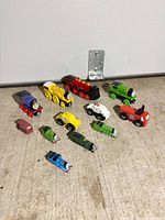 Group shot of all toy trains and cars on floor