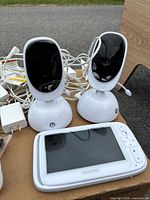 Two Motorola camera units, one Motorola 5-inch monitor, power cords visible