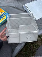 Front angled view of white metal mesh organizer