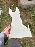 Front view of the unfinished Schnauzer wood cutout showing etched details