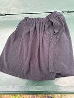 Short dark grey terry cloth wrap towel laid flat showing elastic top and waffle texture