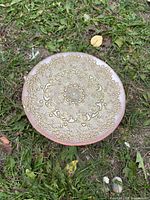 Top view showing embossed floral lace design on pink glass cake stand
