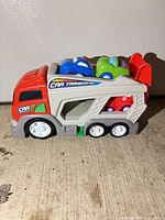 Side view of plastic car transporter with three cars loaded