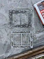 Top view of both decorative metal 5x7 frames lacking glass