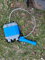 Backpack-style water blaster showing reservoir, hose, and sprayer