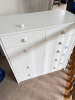 Front view showing five drawers and knobs