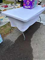 White tablecloth fitted on 6-foot folding table
