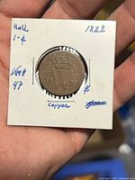 Obverse of 1822 Holland 1 cent coin in flip showing date and partial design