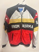 Front view of multicolour Adidas x Rita Ora track jacket showing graphics and pockets