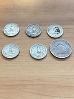 Six coins reverse side showing eagle and Liberty Bell