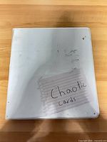 closed white binder labeled Chaotic cards