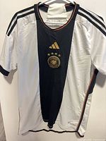 Front view of jersey showing design, crest and Adidas logo