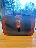 Front view of suitcase showing overall design, color and McBrine logo