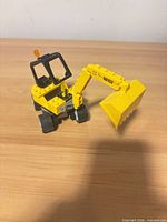 Overall view of Lego wheeled excavator showing cab, boom and bucket