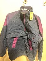 Full view of front of Levi's Skateboarding denim jacket showing color-block design and attached retail tag