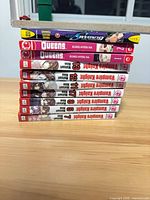 Stacked side view of ten manga volumes showing titles and volume numbers