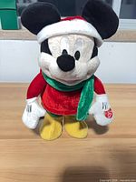 Front view of Mickey Mouse plush in holiday attire