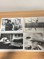 Group view of all four still photographs on tabletop
