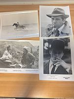 Group shot of all four movie still photographs laid on table