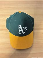 Front view showing green crown, yellow brim, white A's logo