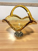 Full view of amber glass basket showing handle, rim and base