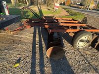 Overview of tow-behind disc harrow showing frame, wheels, hitch and disc gangs