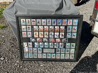 Full view of framed hockey card display on ground
