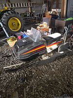 Full view of Yamaha Enticer snowmobile with windshield, seat, and skis visible