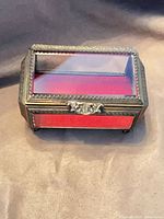 Front view showing beveled glass panels, gilt frame, red velvet interior