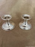 pair of silverplate candlesticks front view