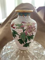 Front view showing chrysanthemum design, gold rim, enamel work