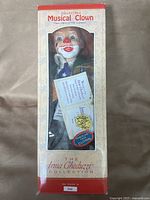 Full boxed view of clown doll inside window box