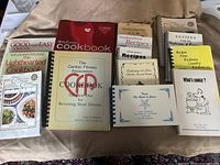 Group shot of all 20 cookbooks spread on surface