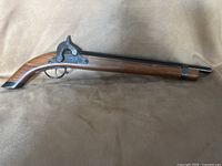 Full view of replica cap gun showing wood stock and metal barrel