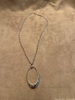 Full view of sterling silver necklace with oval pendant