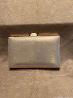Front view metallic champagne side of clutch
