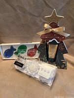 All three packaged items: fish candles set, Stråla LED candles set, hand cream in tree display
