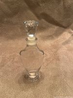 Front view of clear glass Jean d’Albret perfume bottle with stopper