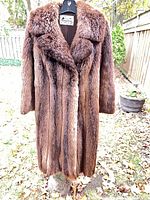 Front view of long brown beaver fur coat