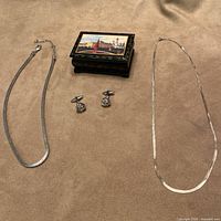 Full lot showing two chains, cufflinks, painted box