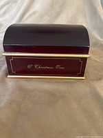 Front view of closed mahogany music box showing O Christmas Tree plaque