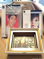 Overall view of three boxed Umbra photo frames