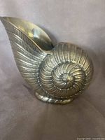 Front view of brass nautilus shell vase