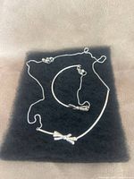 Necklace and bracelet laid out on black background