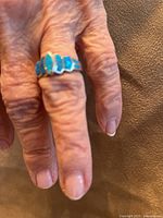 Ring worn on hand showing scale and stone color