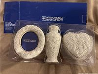 Set in original packaging showing frame, vase, box