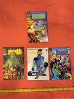 Front covers of all four Elementals issues 20–23 laid out with measuring tape