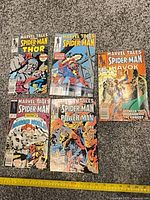 All five Marvel Tales issues laid out on carpet with measuring tape for scale