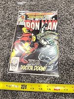 Front cover Iron Man #150 bagged, ruler for scale
